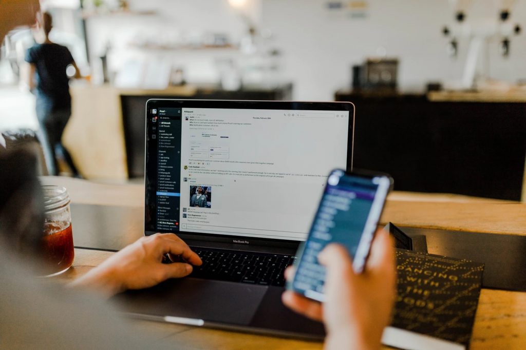 Man working on laptop and phone